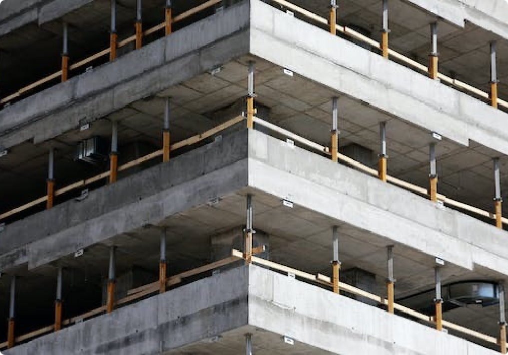 A building under construction with structural beams and engineering efforts